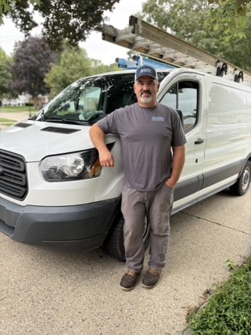 Scott Doree standing next to the Andor work van